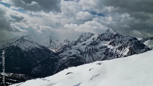 Snowy Mountain Peaks Dominated By Stormy Skies In The Alps