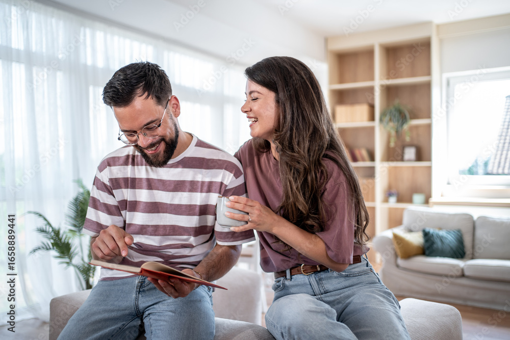 Couple reading a book and enjoying a relaxing morning at home Couple reading a book and enjoying a relaxing morning at home