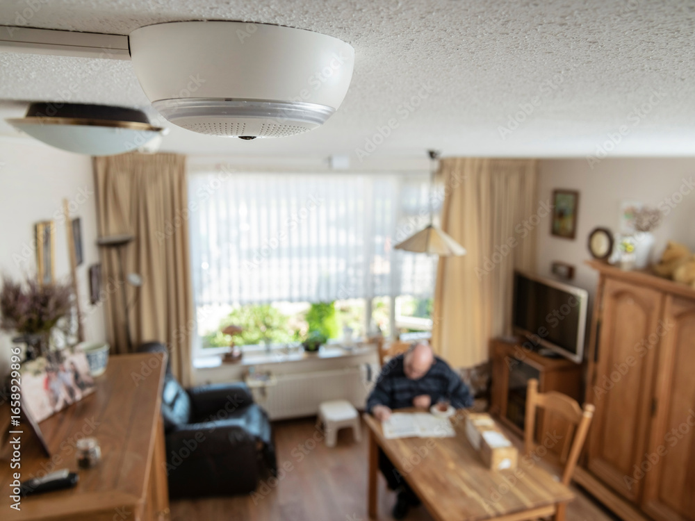 Fototapeta premium Modern living room with visible ceiling-mounted surveillance camera and comfortable home environment