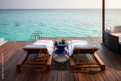 table and chairs on the terrace at a resort in the Maldives