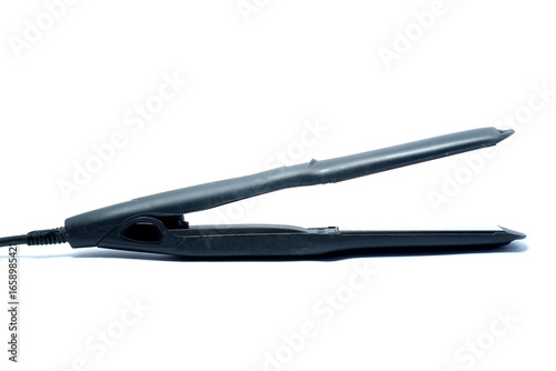 Wallpaper Mural A black electric hair straightener isolated on a white background, symbolizing beauty, grooming, personal care, fashion, salon style, and modern lifestyle. Torontodigital.ca