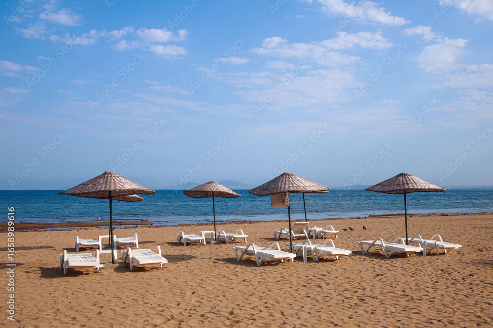 Fototapeta premium beach with umbrellas and chairs