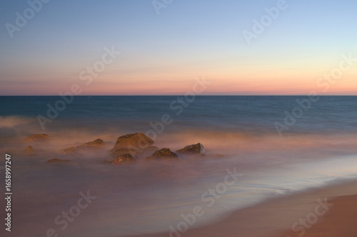Rocks in the Sea at Sunset with Dreamy Mist Effect at Matalascañas