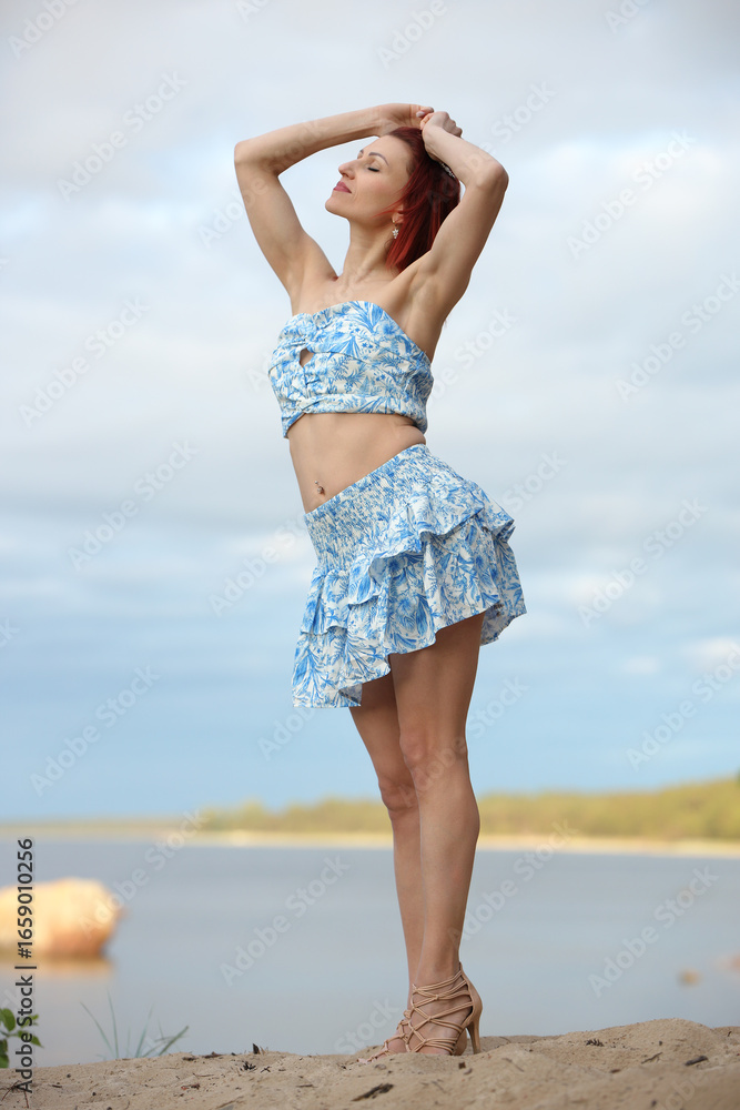 Naklejka premium Joyful Woman Posing by the Sea in Summer