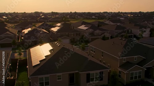 Aerial View of Suburban Neighborhood with Solar Panels at Sunset showcasing renewable energy