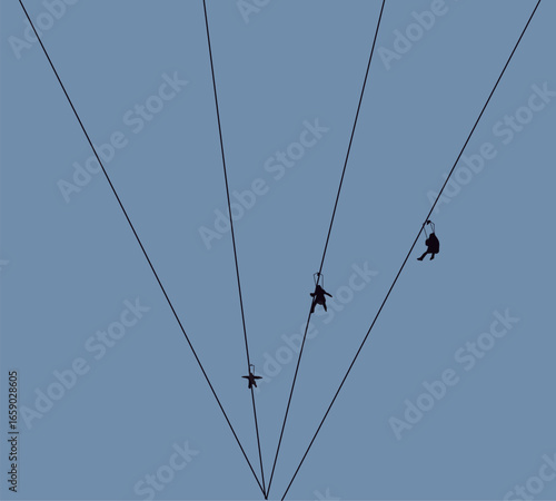 People sliding on zipline over the forest under blue sky. Holiday, adventure, extreme sport concept.
