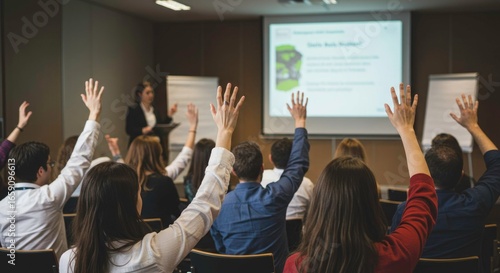Business meeting with participants raising hands for questions