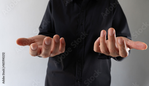 Business person with hands facing forward and palms facing up
