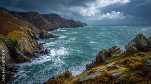 Coastal Wilderness: Dramatic coastal scenery showcases rugged cliffs meeting the turbulent ocean under a moody sky. Capturing nature's raw power and breathtaking beauty.