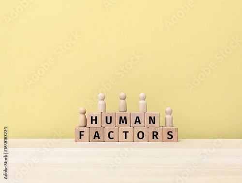 Human Factors text on wooden block , symbolizing psychology, ergonomics, workplace safety, decision-making, and human-centered design.