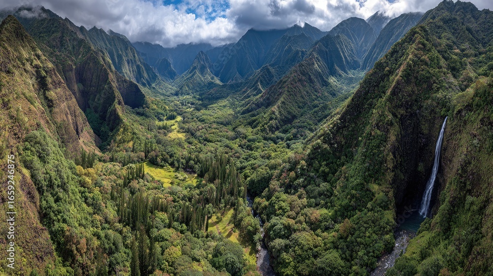 Obraz premium Lush valley with waterfall, dramatic mountains