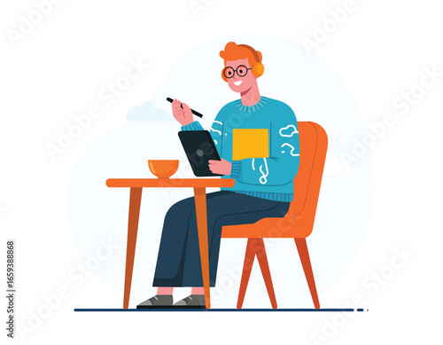 Happy young male digital artist or graphic designer drawing on a graphics tablet with a stylus, listening to music on headphones.