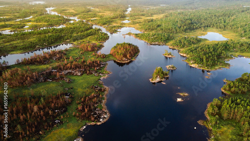 A beautiful lake in Norway (Mykland) in the morning sunrise. Rivers leading in different directions. Shot on a drone.
