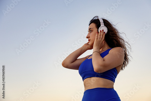 Wallpaper Mural Young woman in sportwear outdoors at sunset Torontodigital.ca