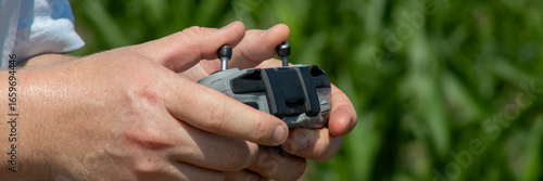 Fotografia Sun-kissed hands of a Caucasian male deftly maneuvering a drone controller, echo