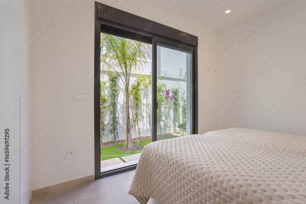 Fototapeta premium Bedroom with Garden Access Through Sliding Door