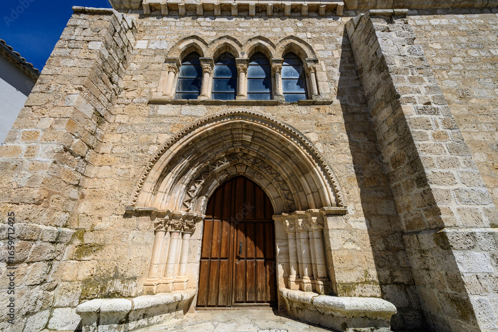 Fototapeta premium Romanesque entrance of San Miguel Arcangel church in Vertavillo with arched doorway