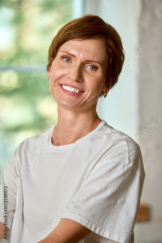 Mature woman in white shirt smiling with positive energy. Concept of confidence, healthy lifestyle, self-care, happiness, aging gracefully and authentic beauty. Free Download Mature woman in white shirt smiling with positive energy. Concept of confidence, healthy lifestyle, self-care, happiness, aging gracefully and authentic beauty. - GFXLoad