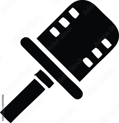 Silhouette of a film reel handle symbolizing cinema production with perforated edges capturing the essence of moviemaking and filmmaking artistry.