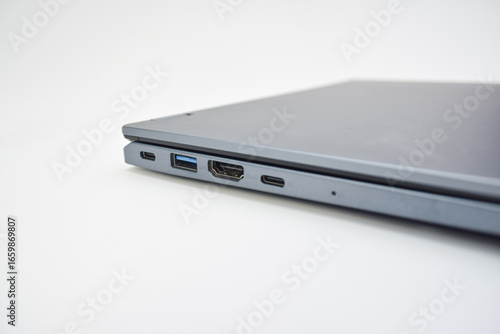 Closed laptop showing side ports including USB, HDMI, and Type-C, concept of connectivity, modern technology, and portable computer design.