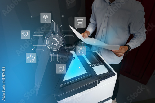 Bild auf Leinwand Man operates a multifunction printer in a modern office environment while using