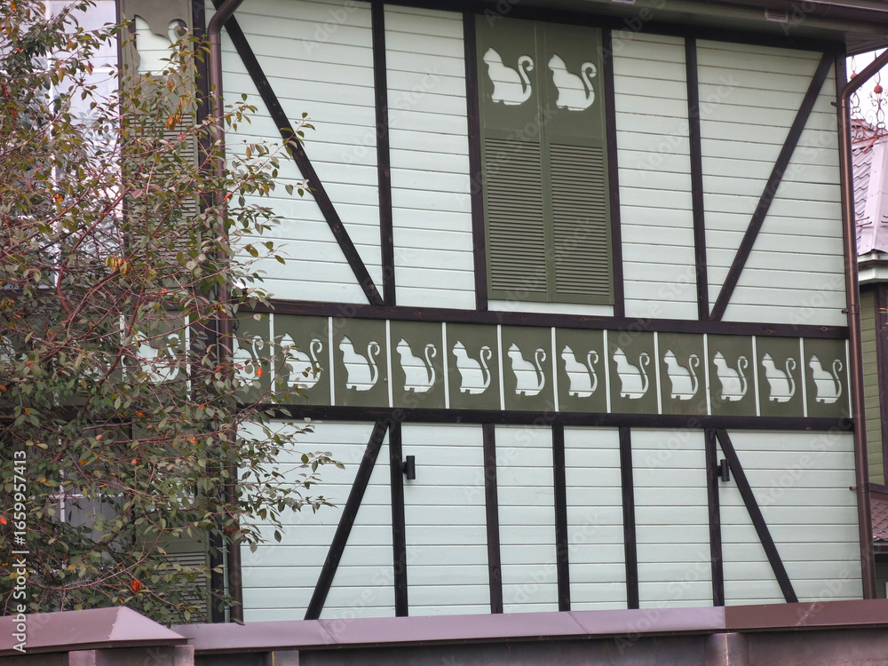 Fototapeta premium funny house with silhouettes of cats on the facade