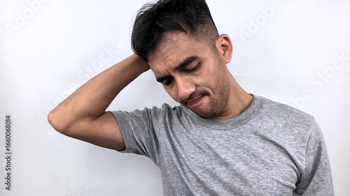Young Man Feeling Tired and Unwell Against White Background.