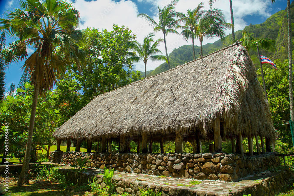 Rustic thatched-roof hut surrounded by lush palm trees and vibrant greenery. Kepaniwai park, Wailuku, Iao valley, Maui, Hawaii Rustic thatched-roof hut surrounded by lush palm trees and vibrant greenery. Kepaniwai park, Wailuku, Iao valley, Maui, Hawaii