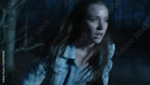 Woman running scared in dark forest at night