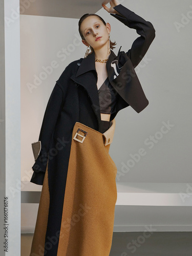 Fashion model in stylish outerwear with unique textures and colors posing elegantly.