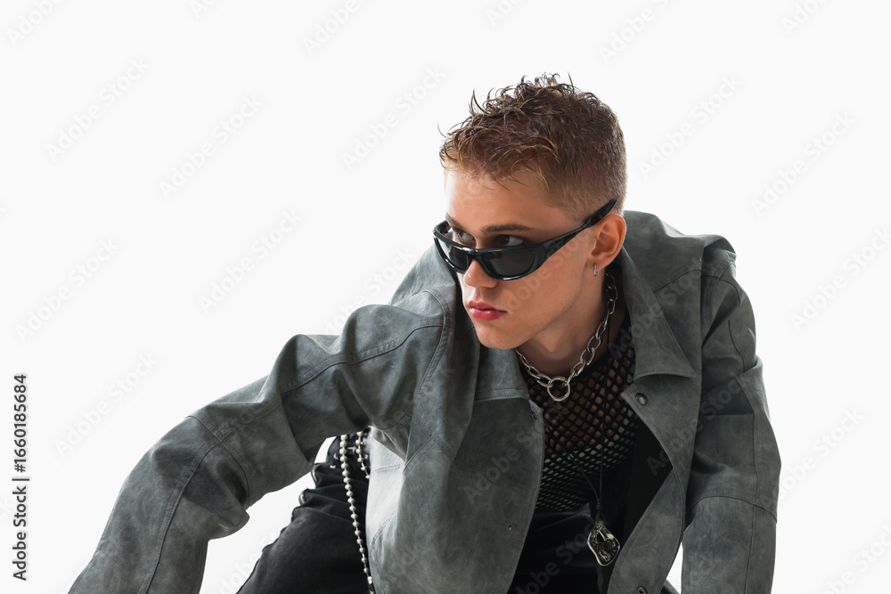 Obraz premium Handsome young man wearing stylish jacket and sunglasses on white background