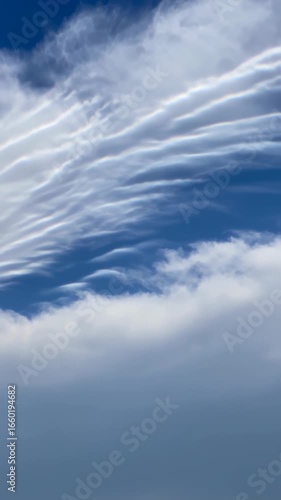 Ethereal Sky: Drifting Clouds in a Deep Blue Expanse - Serene Atmospheric Beauty