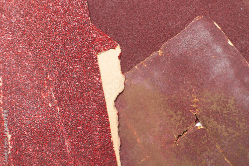 Pieces of used sheet of red sandpapers isolated on a white background