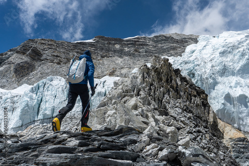 A male climber is approaching the fixed ropes on Island Peak during an expedition in Nepal.