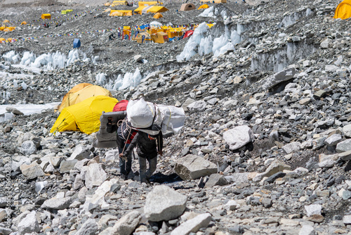 Porters carrying heavy loads to Everest base camp during an expedition in Nepal.