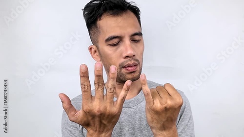 Man Looking at Hands, Close-Up, White Background.