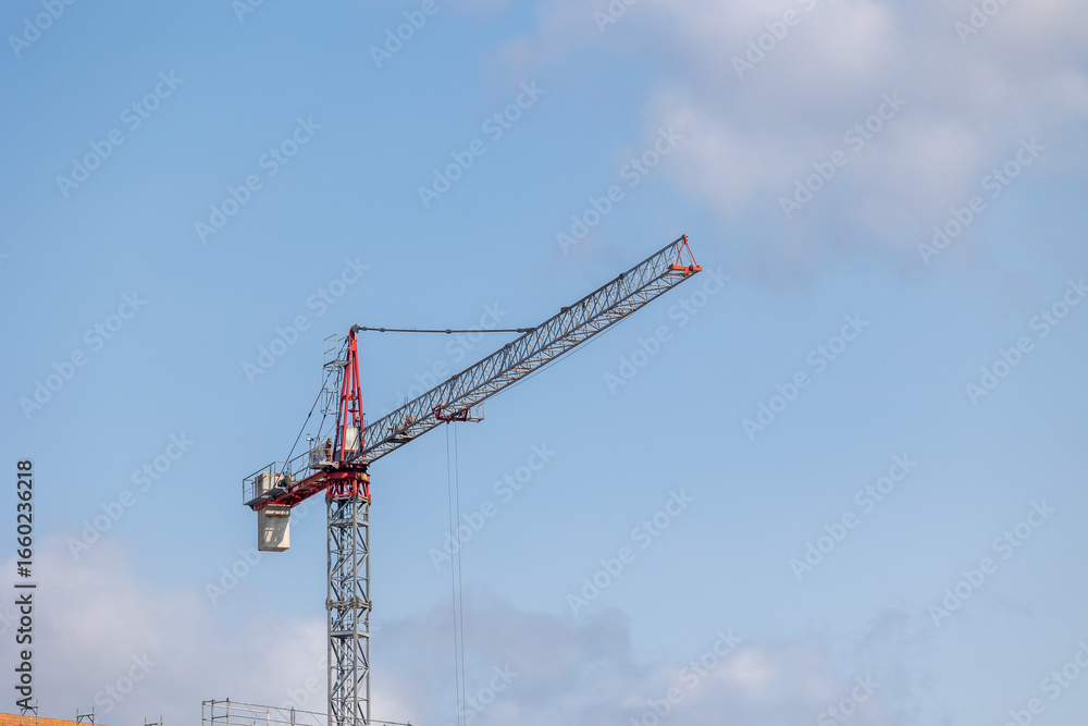 Construction crane dominating skyline during building process Construction crane dominating skyline during building process