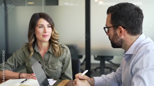 Wallpaper Mural Two Professionals in a Business Meeting Discussing Work at a Table Colleagues Collaborating on Project in Modern Office Setting Teamwork and Strategy Torontodigital.ca