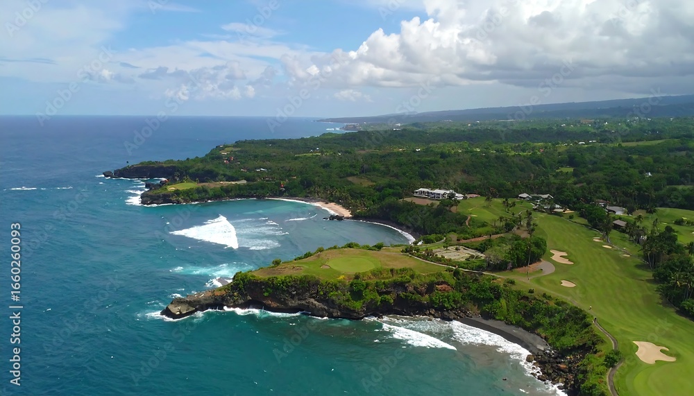 Fototapeta premium A sweeping vista of a tropical coastline featuring a picturesque bay, lush greenery, and a golf course, showcasing the natural beauty of a remote island paradise.