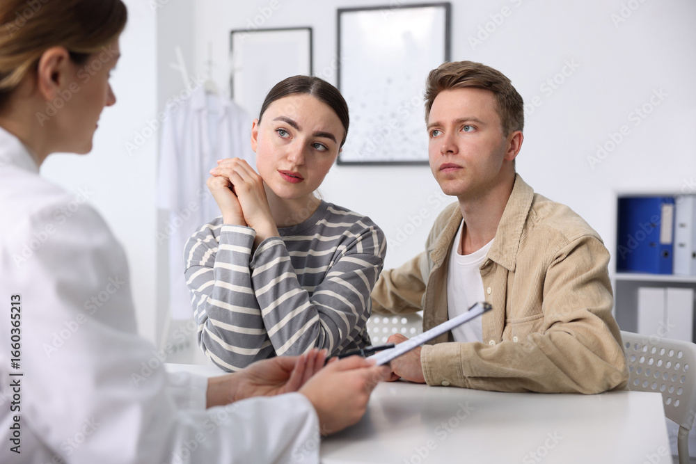 Fototapeta premium In vitro fertilization (IVF). Couple having appointment with doctor in reproductive clinic