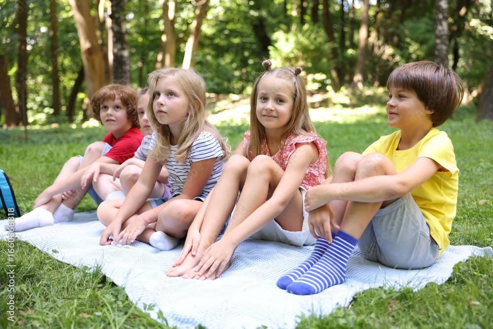 Fototapeta premium Cute little kids on green grass in park