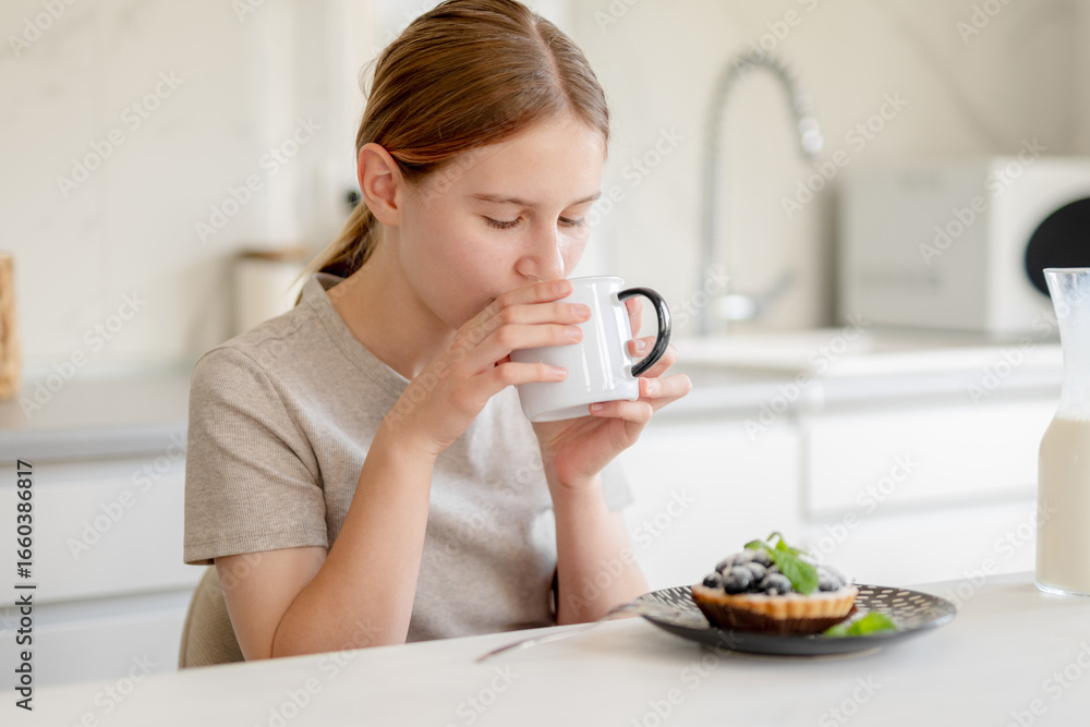 Teen Girl Drinking Milk At Breakfast In The Kitchen At Home Teen Girl Drinking Milk At Breakfast In The Kitchen At Home