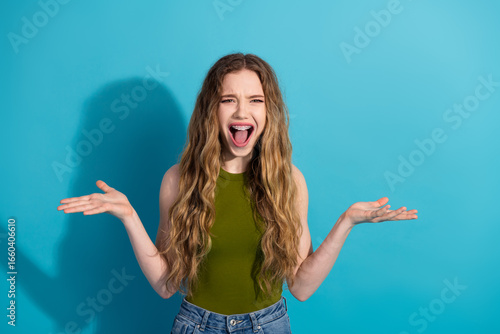 Papier peint Portrait of excited young woman in casual outfit gesturing enthusiastically on b