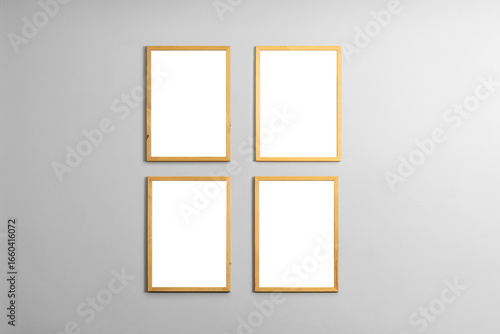 Modern minimal interior with one two three  four  five blank wooden photo frames light gray wall  vertical mockup template for artwork  posters or prints  Scandinavian design  home decor  gallery wall