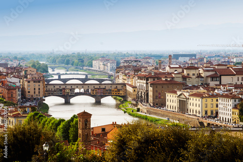 Top panoramic view of Ponte Vecchio bridge on Arno river and old part of Florence, Tuscany, Italy