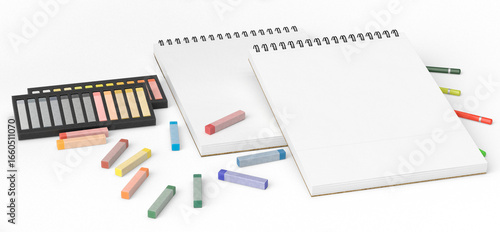 Blank spiral sketchbook surrounded by colorful pencils, pastel chalks, and pencil sharpeners on a white background. Artistic workspace concept. Suitable for drawing, sketching, creative design, educat
