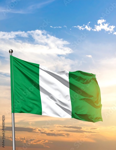 Nigerian flag waving against a vibrant sunset sky