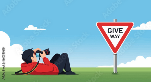 A photographer in nature captures the roadsign 'give way' on a serene day under a blue sky