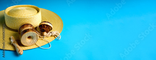 Fotografía Traditional chilean wooden toys trompo and emboque displayed on a straw hat, sug