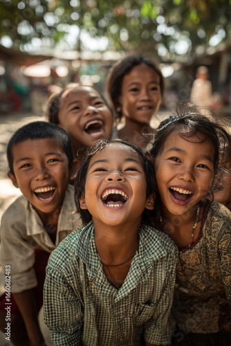 A group of local children playing a traditional Burmese game in a village square, their joyful faces radiating happiness.
